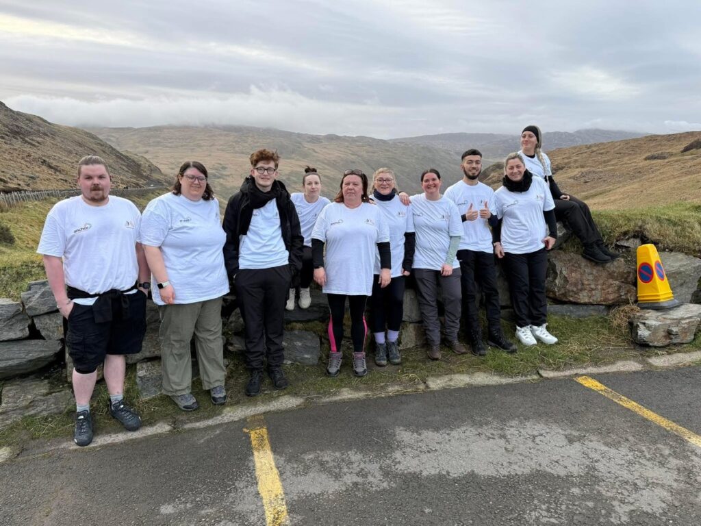 The Glenvale Park Care Home fundraising team in white t-shirts at the foot of Snowdon