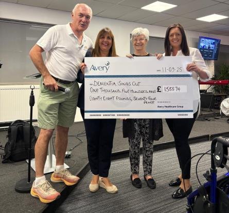 Staff from Squires Mews Care Home presenting a cheque for over 1,500 pounds to Dementia Sings Out