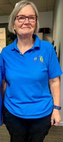 Susan, a DSO volunteer, wearing the new turquoise Dementia Sings Out polo shirt